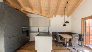 Wohnraum mit Küche und Sichtdachstuhl im Bauprojekt Uttendorf